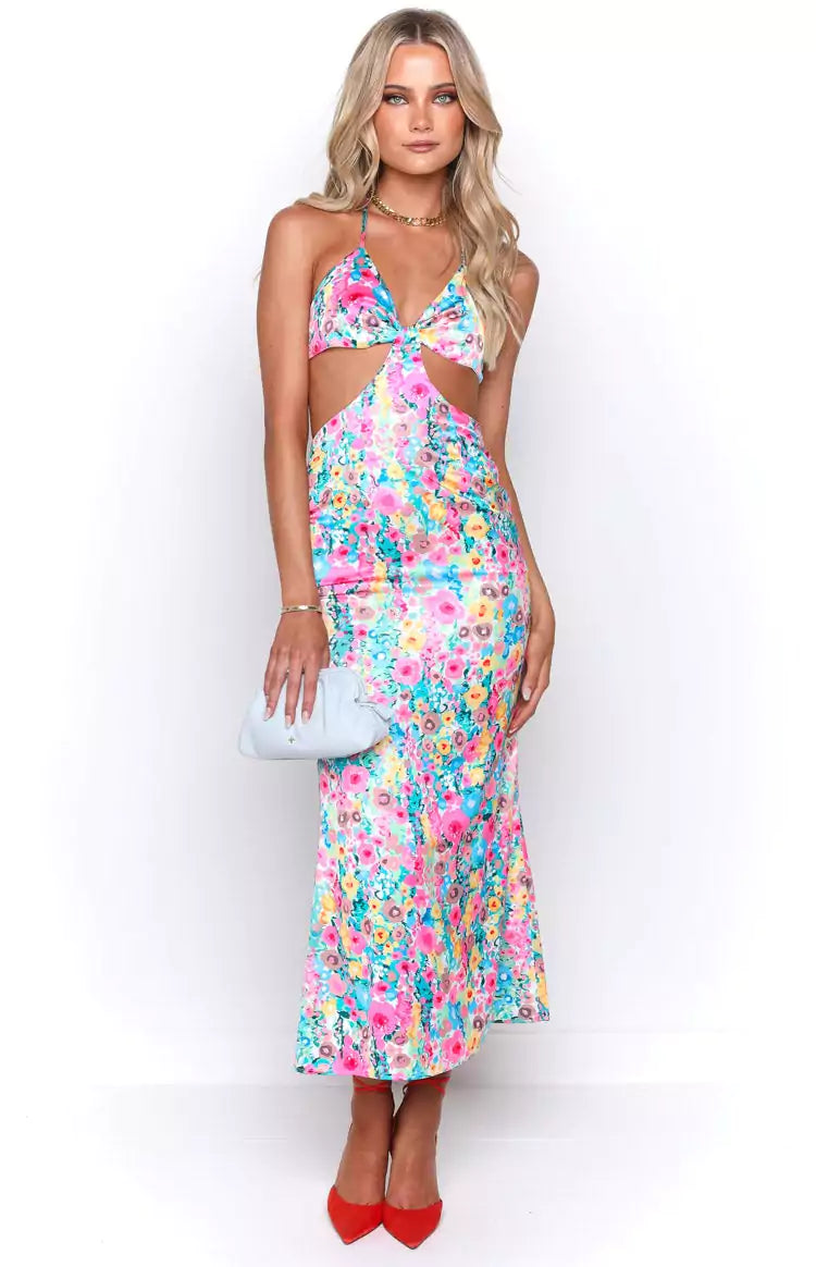 A model wearing a floral print midi dress.