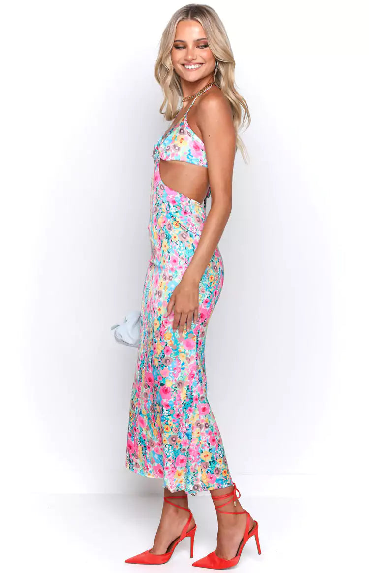 The model is wearing a floral cut out midi dress.