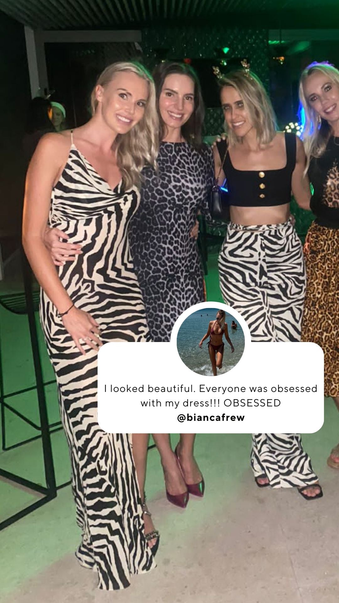 Four women in zebra print dresses posing for a photo.