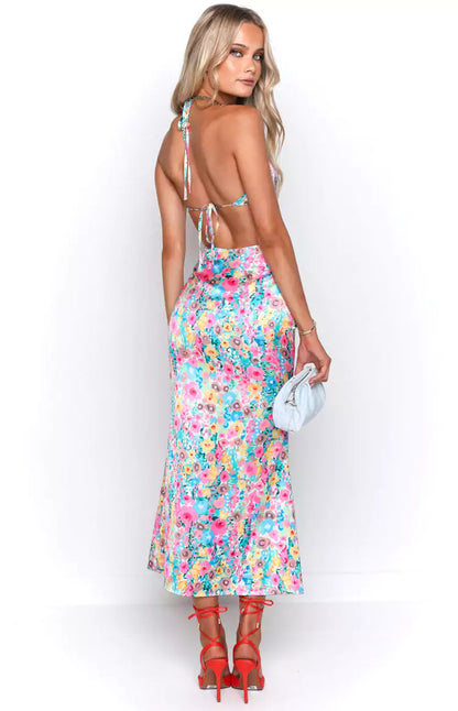 The back view of a woman wearing a floral midi dress.