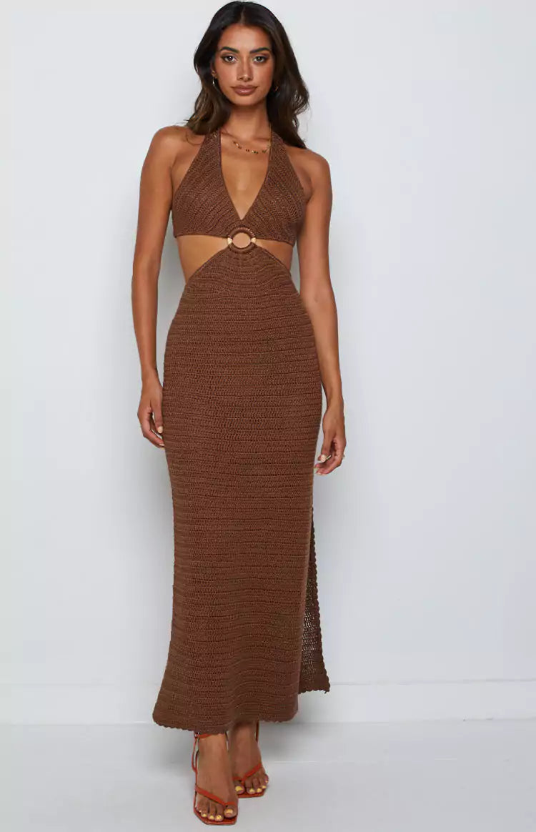 A woman wearing a brown crochet maxi dress.
