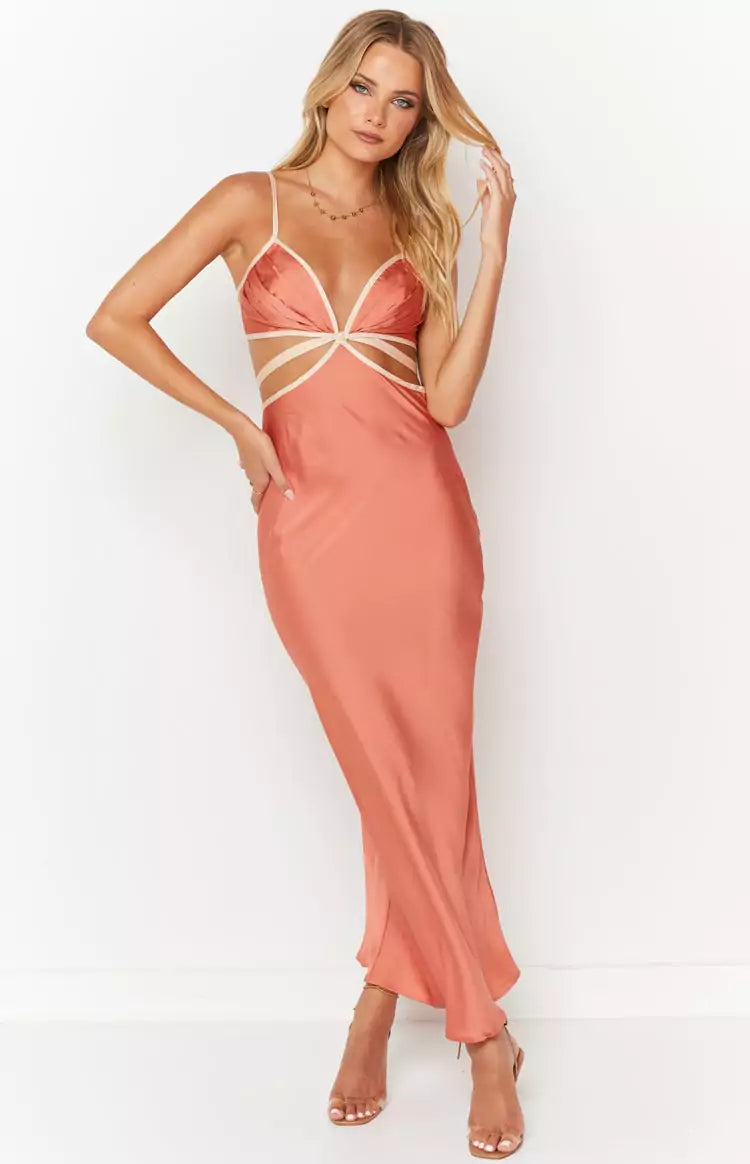 A woman wearing a peach satin slip dress.