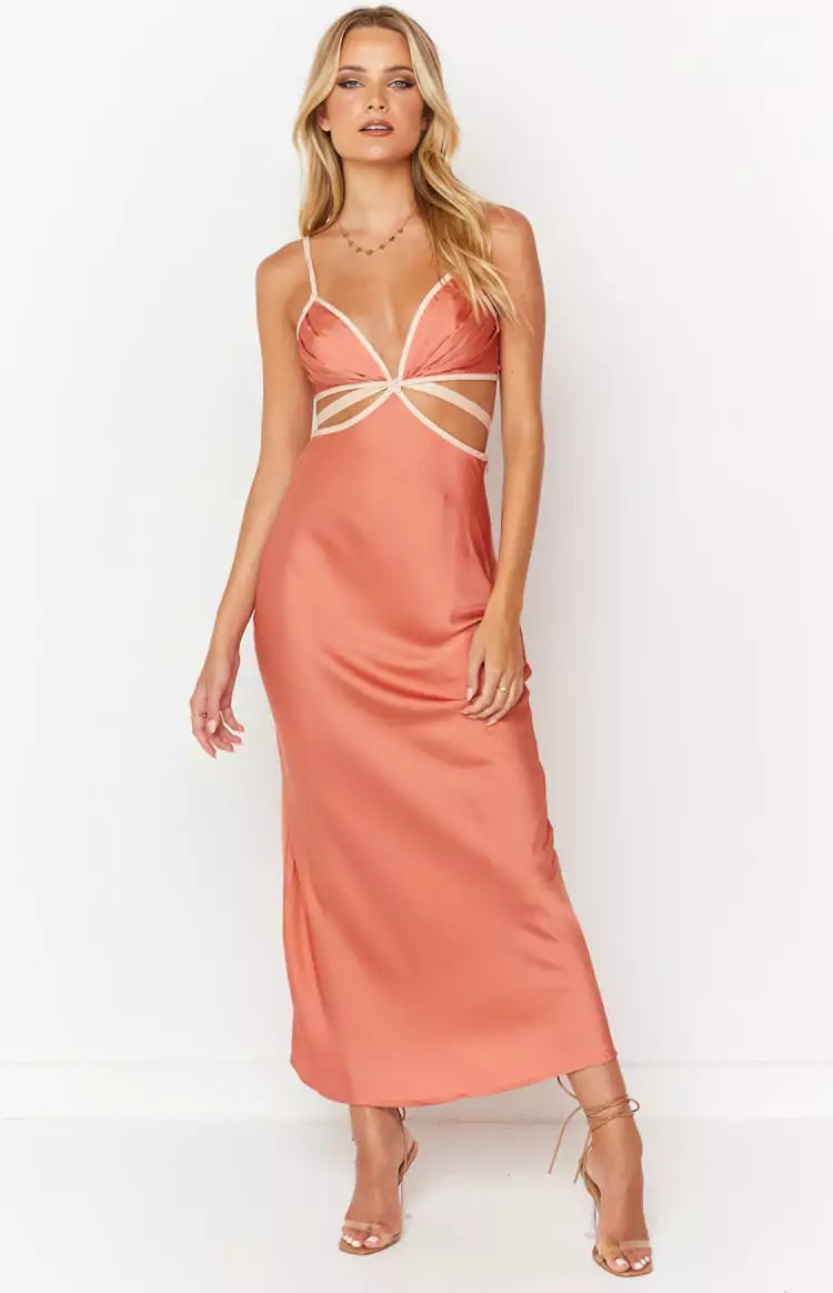 A woman wearing a peach satin midi dress.