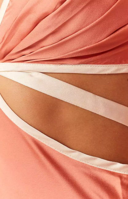 A close up of a woman in a peach dress.