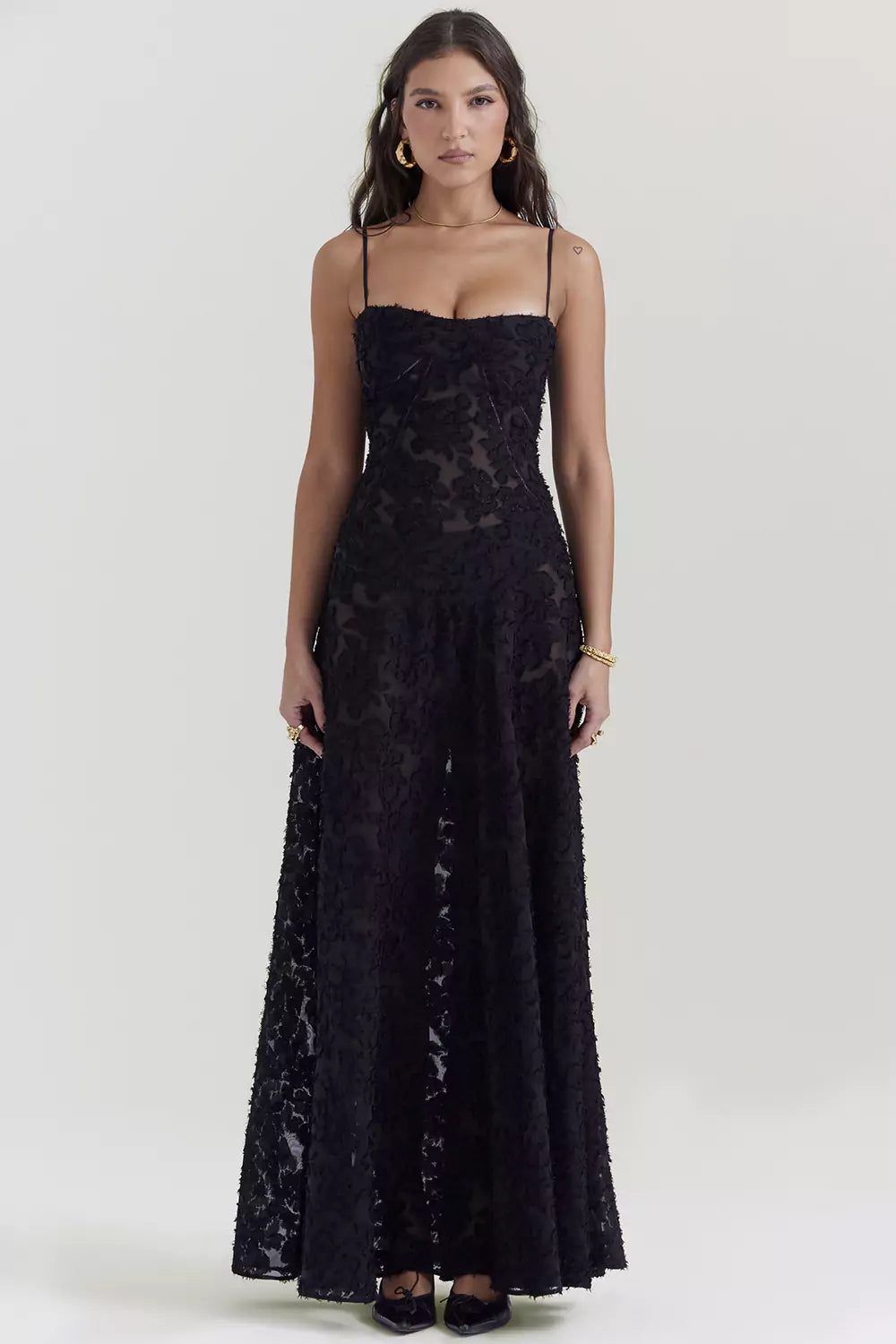 The model is wearing a black lace dress.