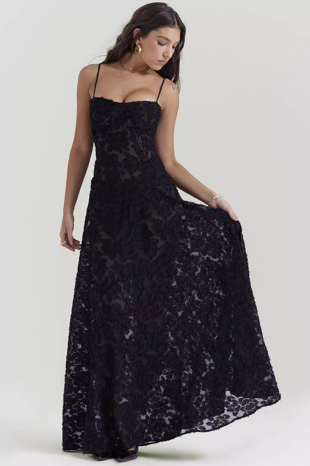 A woman wearing a black lace dress.