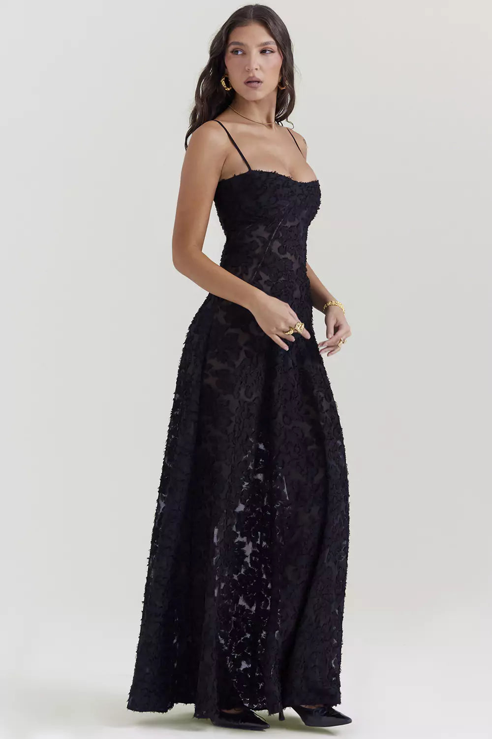 The model is wearing a black lace dress.
