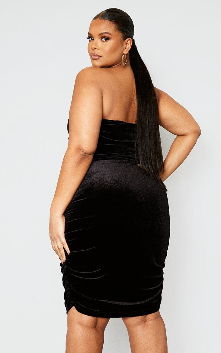 Plus size black velvet ruched midi dress, perfect for a black tie event.
