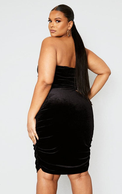 Plus size black velvet ruched midi dress, perfect for a black tie event.